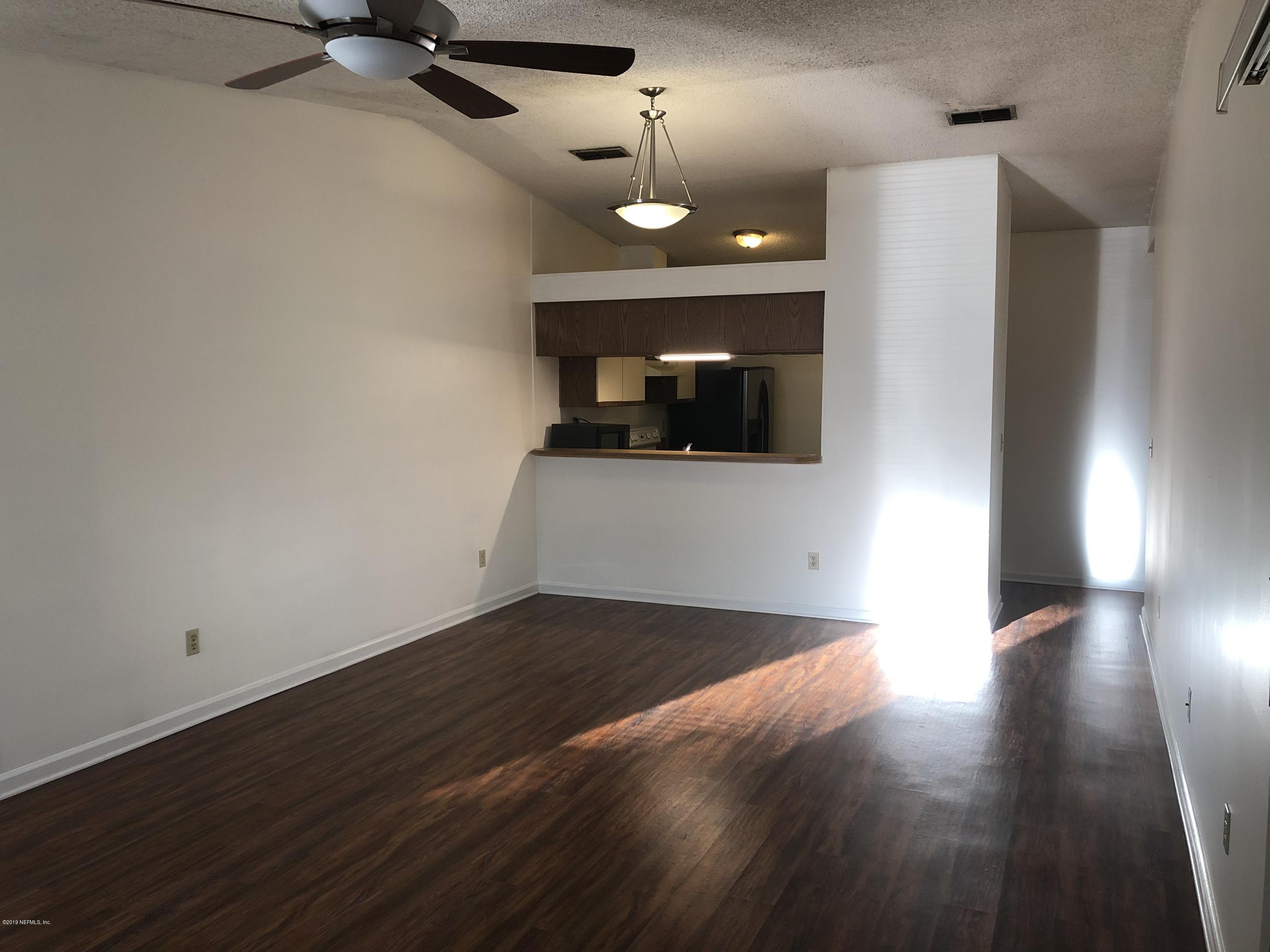 3801 Crown Point Road, Unit 3023 Jacksonville, FL 32257 - Photo 6 of 18 a view of a livingroom with a flat screen tv and fireplace