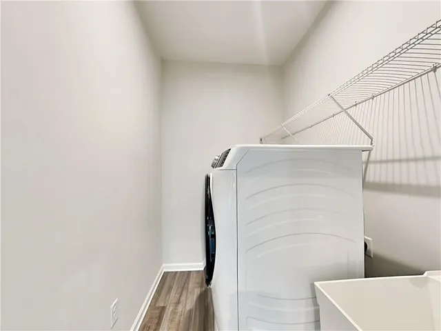 a white toilet sitting next to a white wall