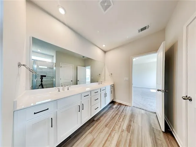 a bathroom with a glass shower door