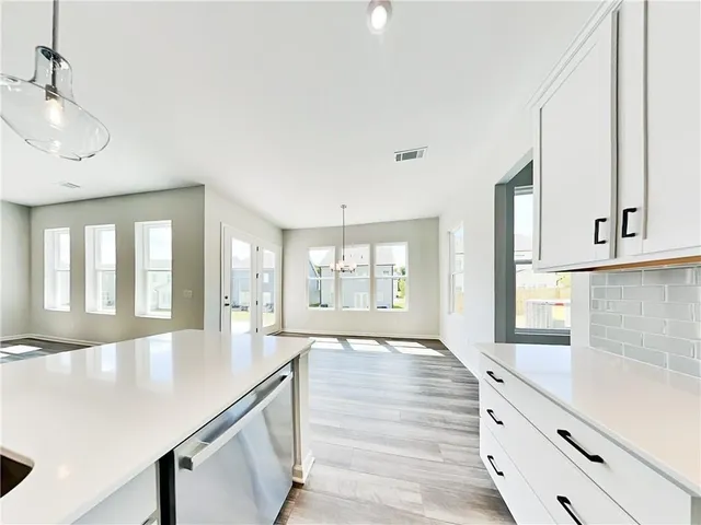 a large white kitchen with a large window
