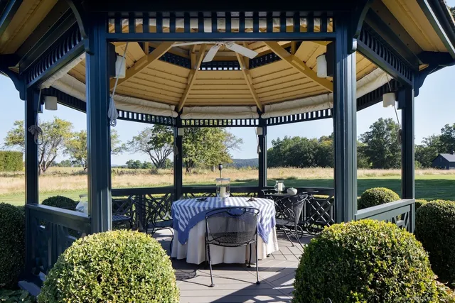 a bedroom with furniture and a large window