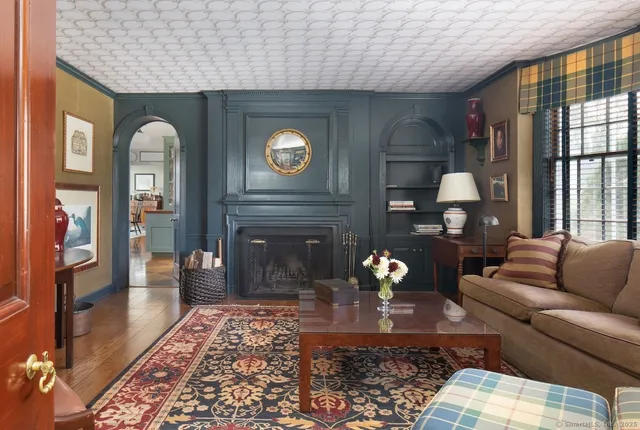 a living room with furniture and a fireplace