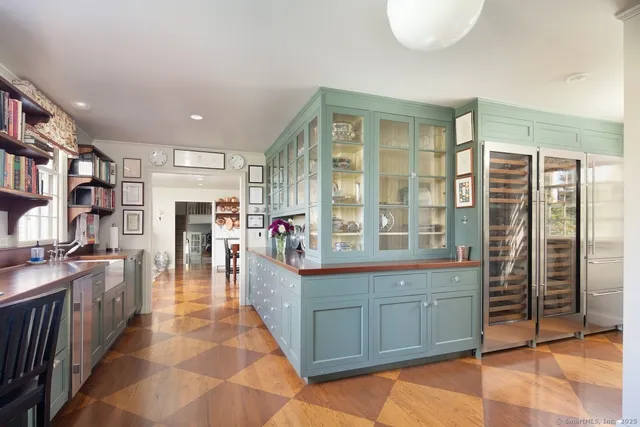 a dining hall with stainless steel appliances granite countertop a stove and cabinets
