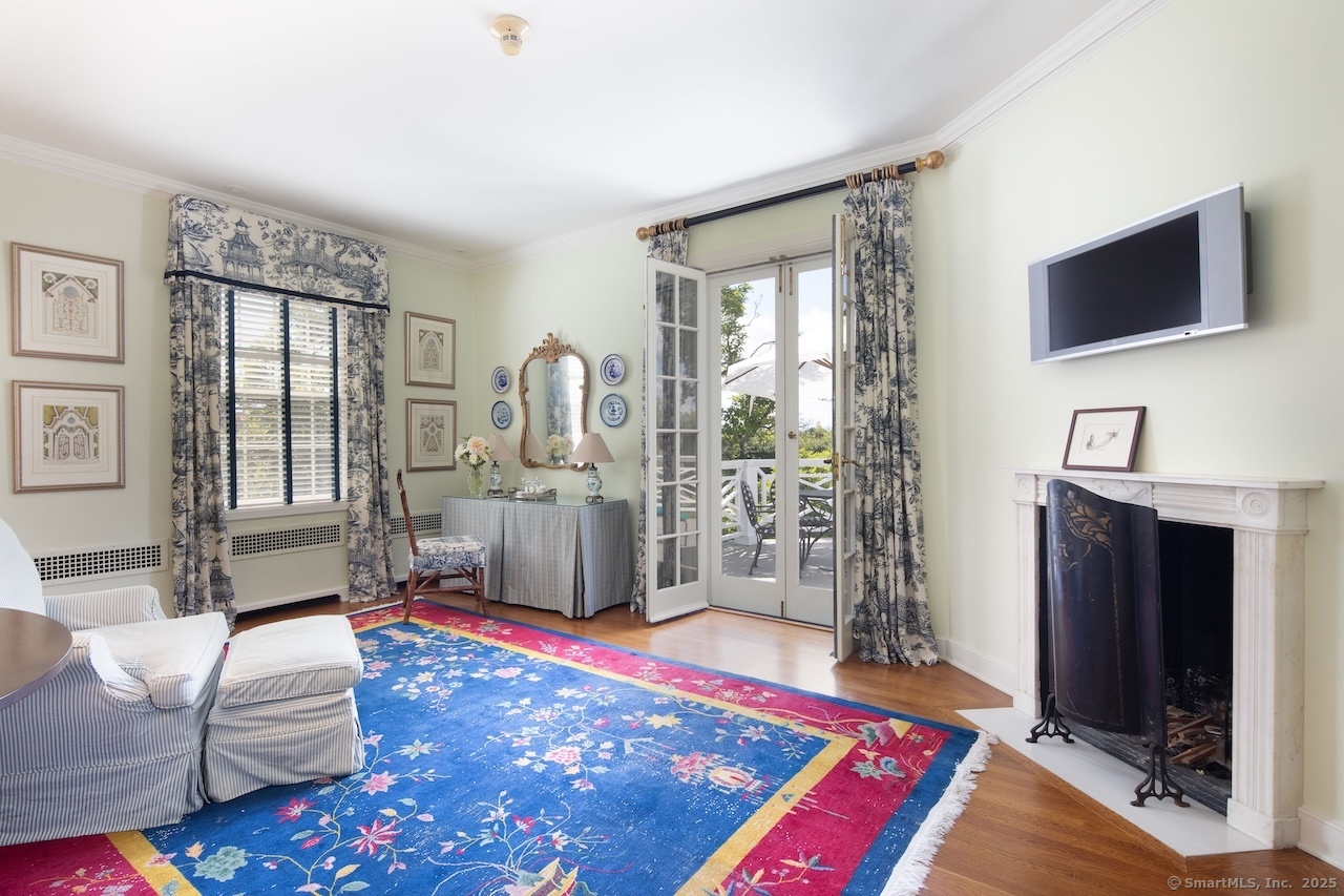 406 Wells Hill Road Salisbury, CT 06039 - Photo 27 of 38 a living room with furniture a flat screen tv and a rug