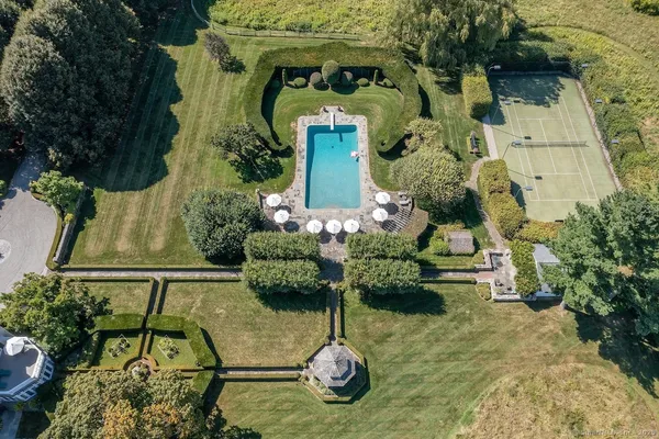 a swimming pool with some potted plants