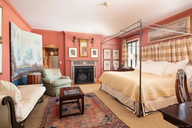 a bedroom with a bed a couch and a window