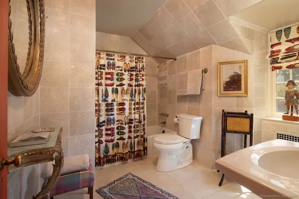 a bathroom with a toilet a sink and a shower