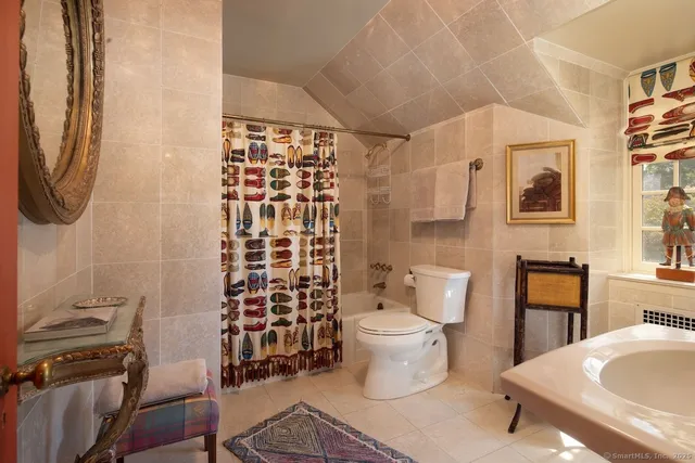 a bathroom with a toilet a sink and a shower