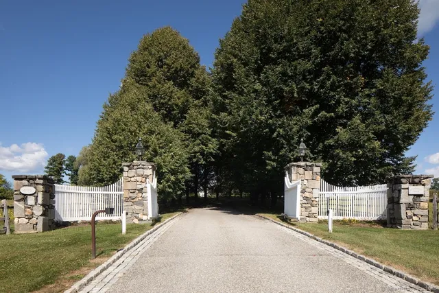 a white house that has tree in front of it