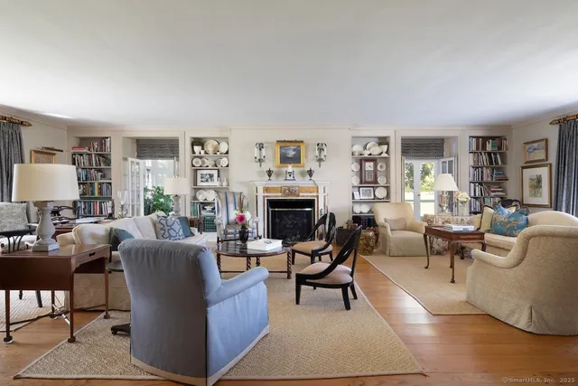 a living room with furniture a rug and a fireplace