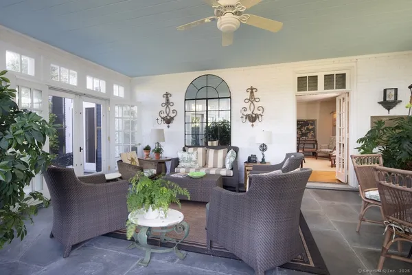 a living room with fireplace furniture and a potted plant