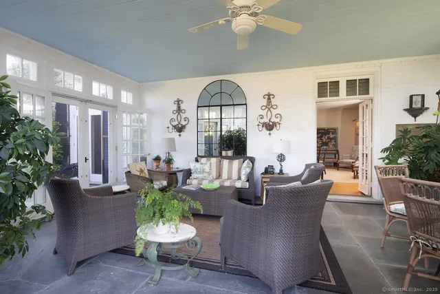a living room with fireplace furniture and a potted plant