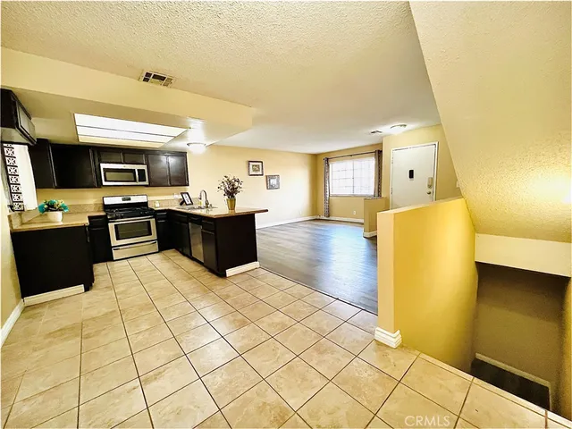 a kitchen with stainless steel appliances a stove a sink and a refrigerator