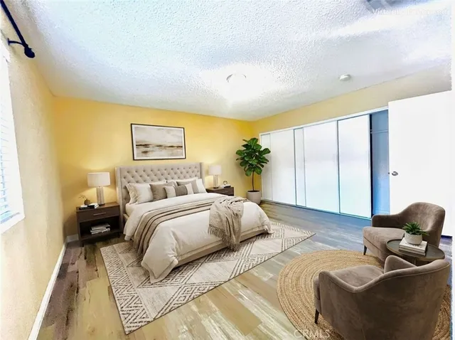 a spacious bedroom with a bed and a couch