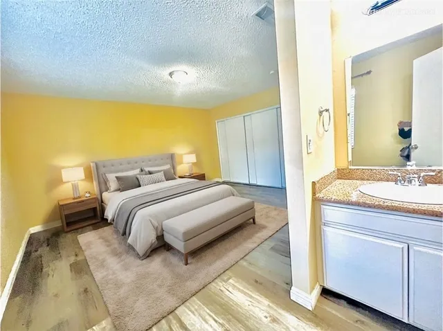 a bedroom with a bed and a sink