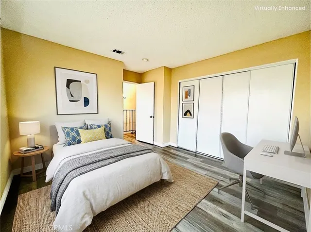 a bedroom with a bed and painting on the wall