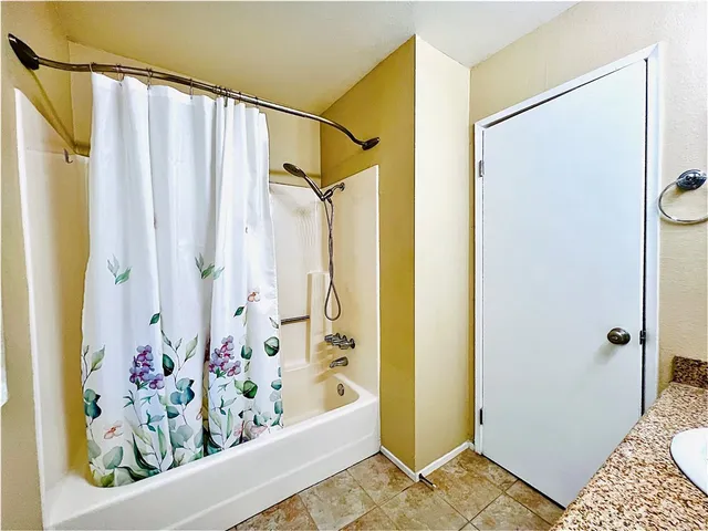 a bathroom with a bathtub and shower