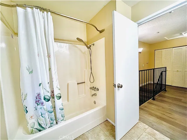 a bathroom with a bathtub and a shower