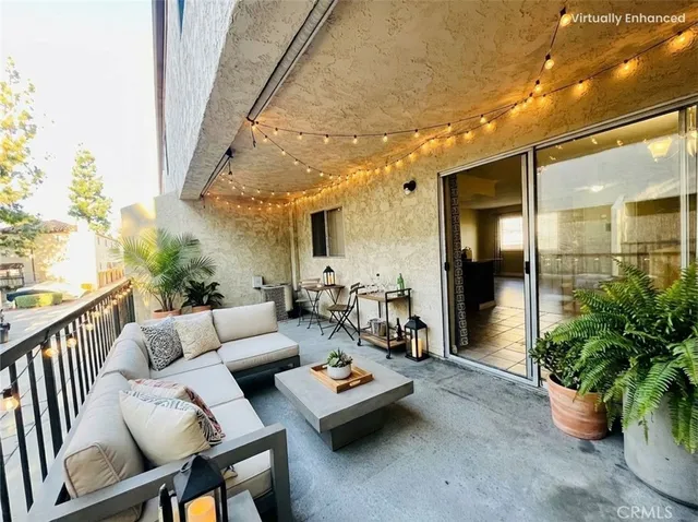 a living room with furniture and potted plants