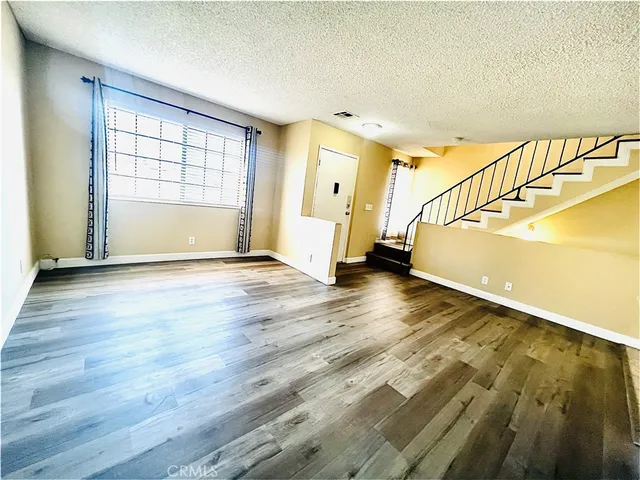 a view of an entryway with wooden floor