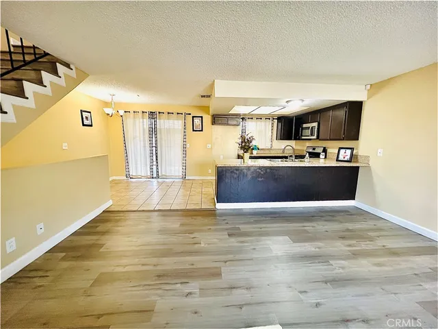 a view of a kitchen with a sink and a refrigerator