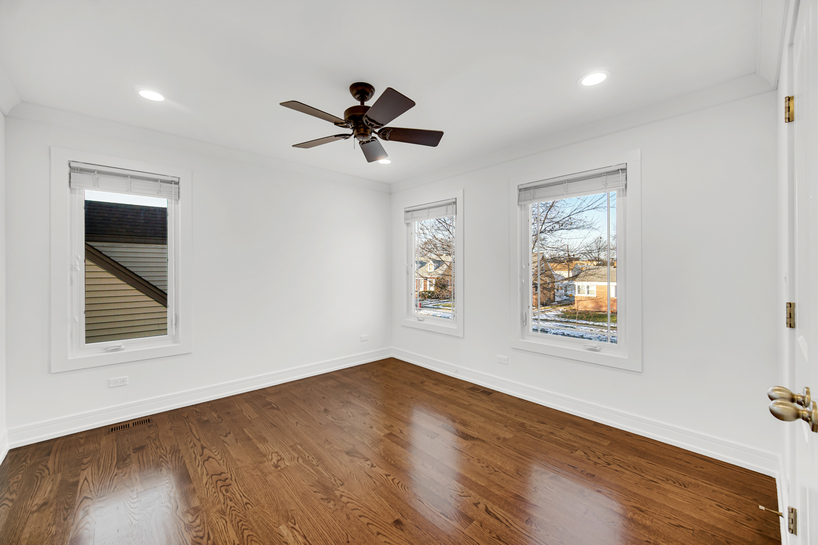 5817 Crain Street Morton Grove, IL 60053 - Photo 11 of 20 a view of empty room with wooden floor and fan