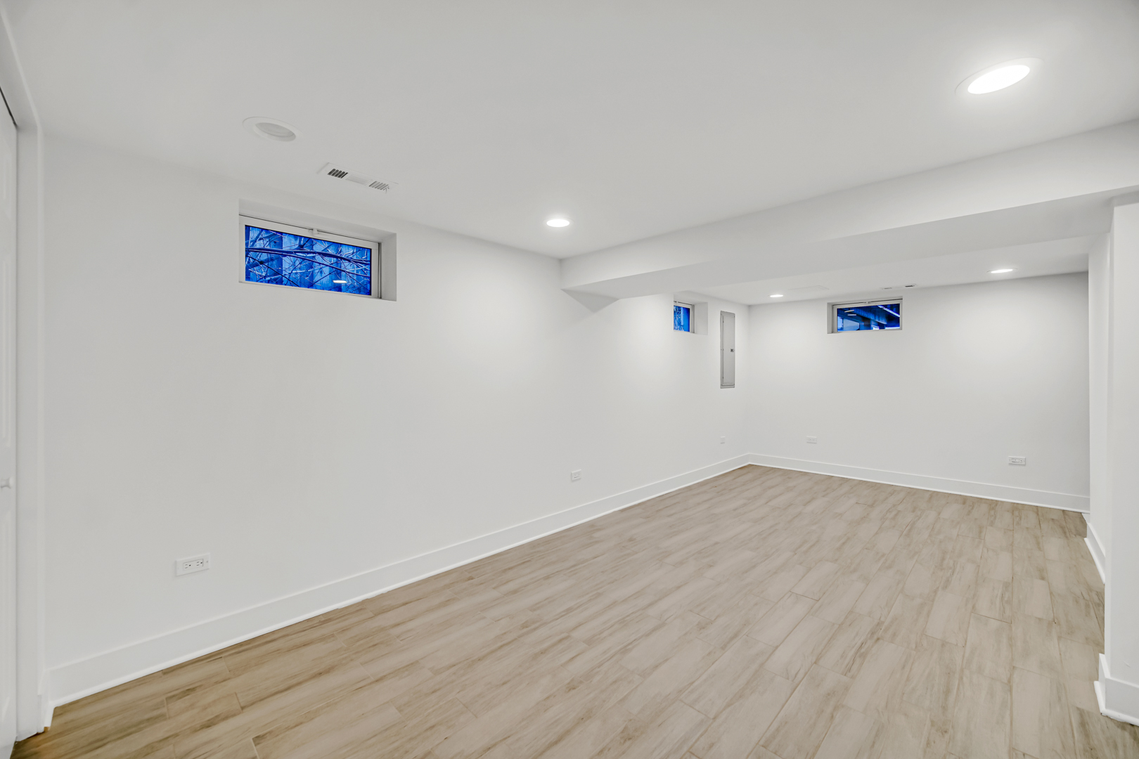 5817 Crain Street Morton Grove, IL 60053 - Photo 17 of 20 an empty room with wooden floor and windows