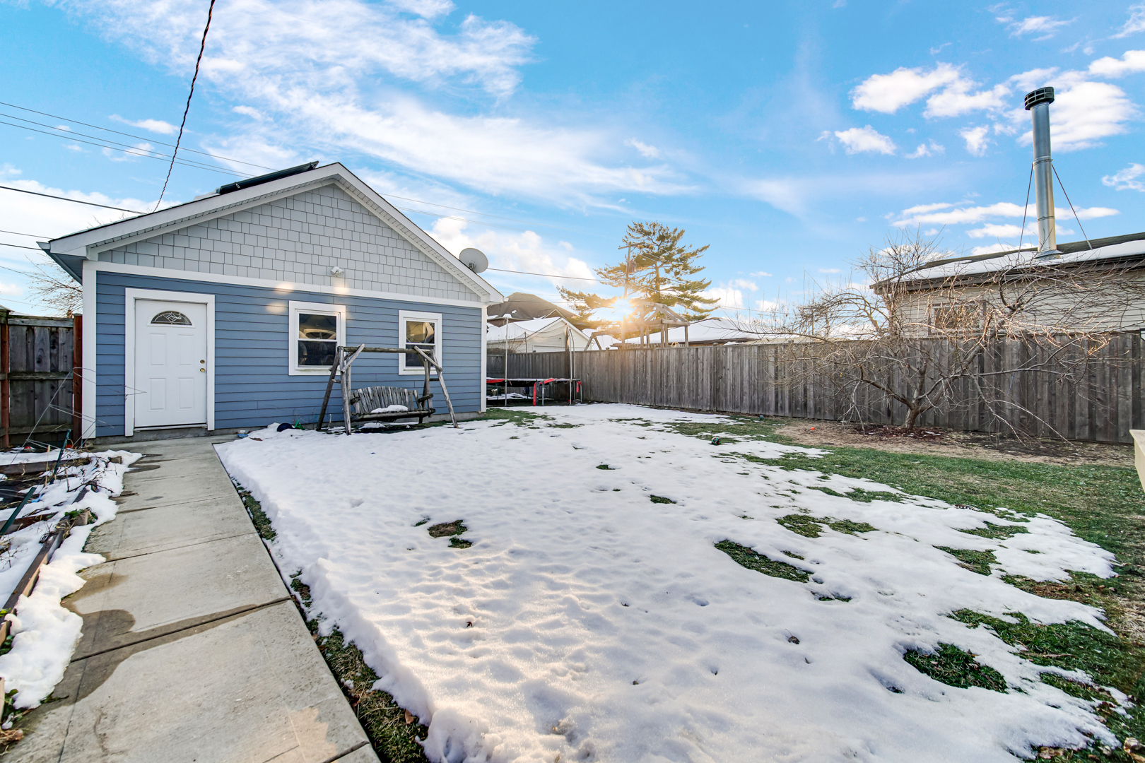 5817 Crain Street Morton Grove, IL 60053 - Photo 20 of 20 a view of a house with a yard covered in snow