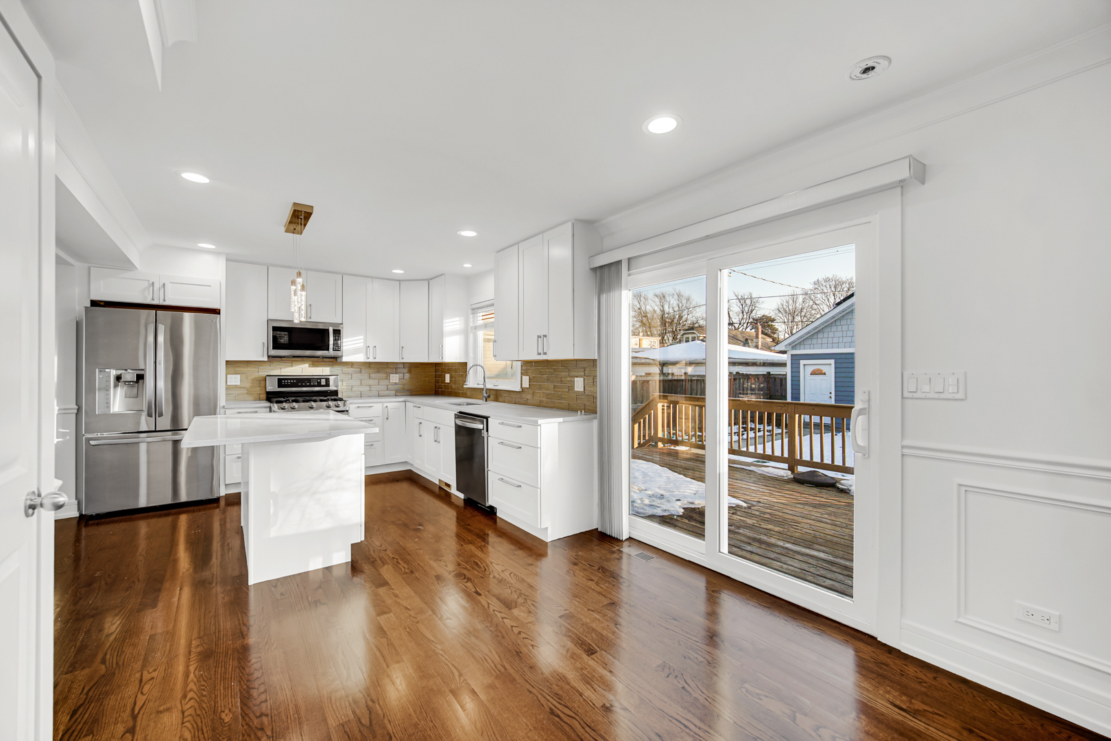 5817 Crain Street Morton Grove, IL 60053 - Photo 6 of 20 a kitchen with a refrigerator and white cabinets