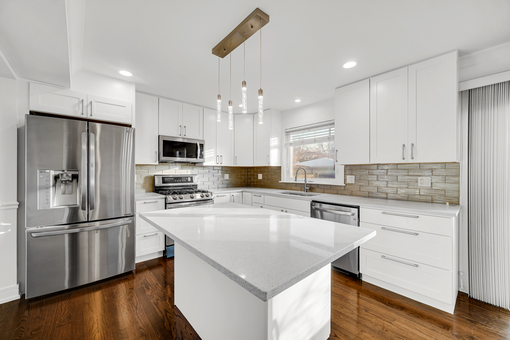 5817 Crain Street Morton Grove, IL 60053 - Photo 9 of 20 a kitchen with stainless steel appliances granite countertop a refrigerator a stove a sink and a microwave