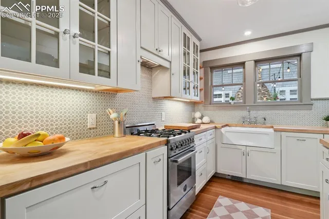 a kitchen with stainless steel appliances white cabinets and a stove top oven