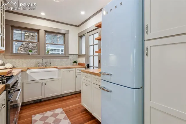 a room with a sink cabinets and a window
