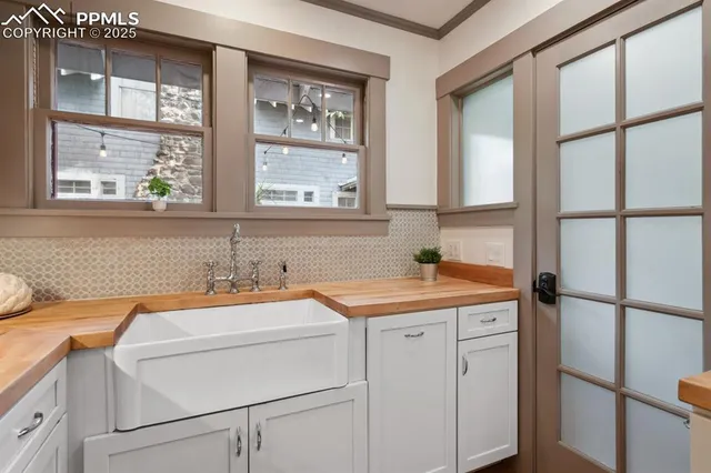 a utility room with dryer and windows