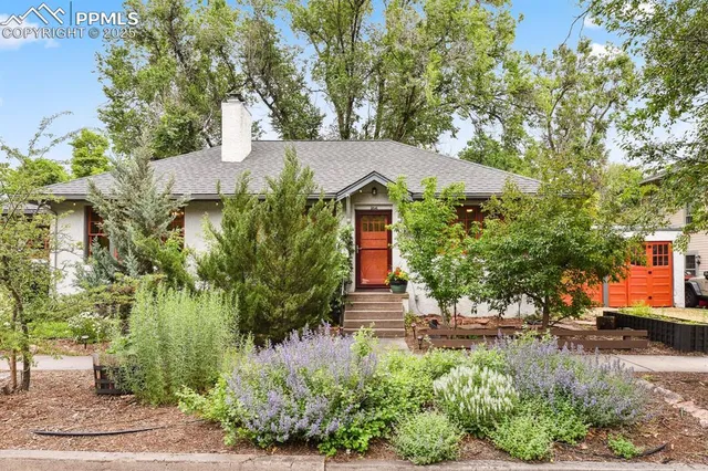 a front view of a house with a yard and fountain