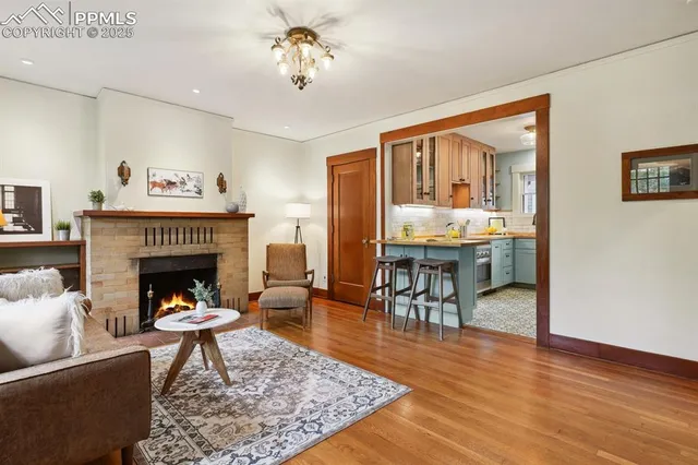 a living room with furniture and a fireplace