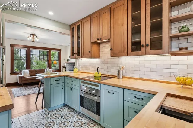 a kitchen with a sink stove and cabinets