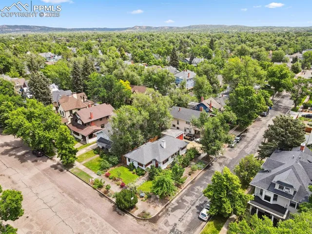 an aerial view of a house with a yard