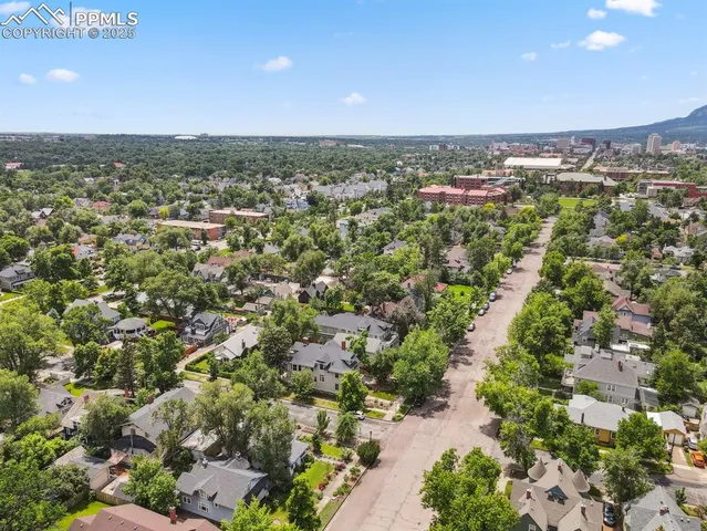 an aerial view of a residential houses with city view