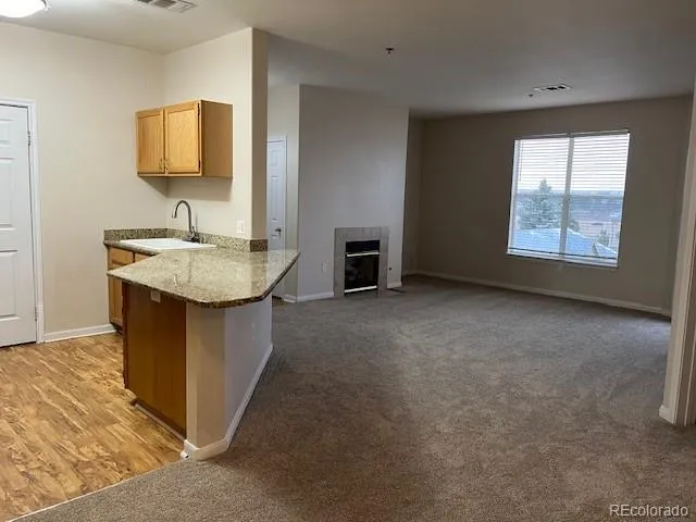 a hall with a sink cabinets and a flat screen tv
