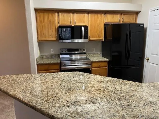 a kitchen with a refrigerator and a microwave