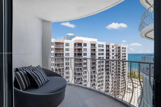 a living room with furniture and large windows