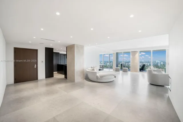 a view of a living room and kitchen with furniture