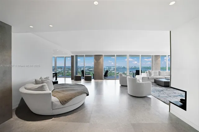 a living room with fireplace furniture and a potted plant