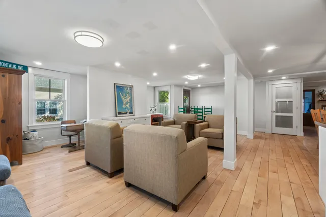 a dining room with furniture and wooden floor