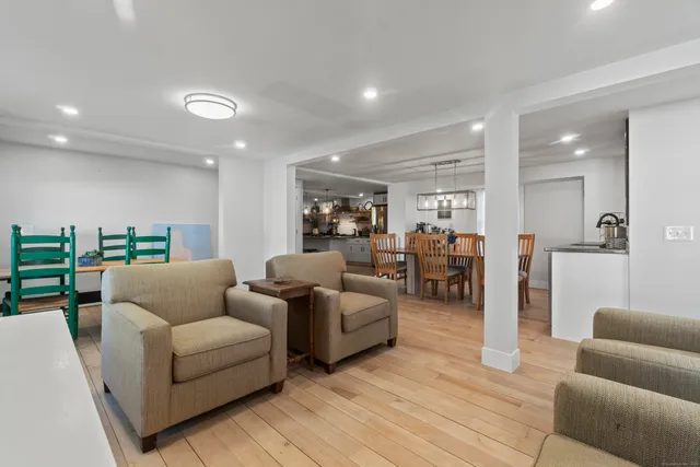 a kitchen with stainless steel appliances granite countertop a refrigerator a stove and a wooden floors