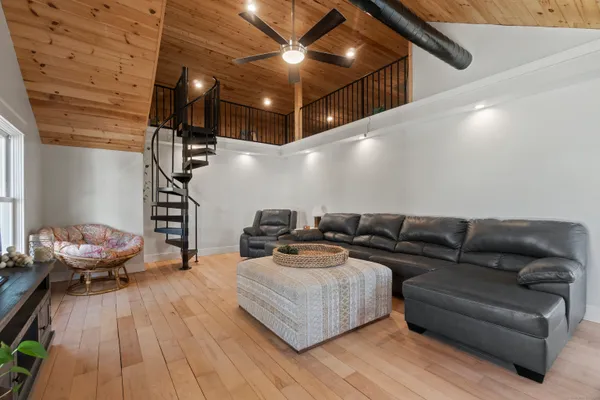 a living room with furniture and a wooden floor