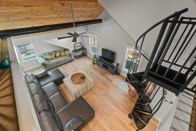 a view of a hallway with a livingroom with furniture