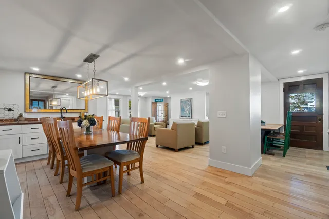 a dining room with furniture and wooden floor