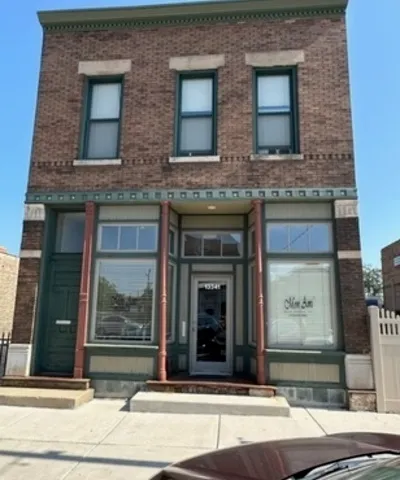 a view of a brick building with a door side of it