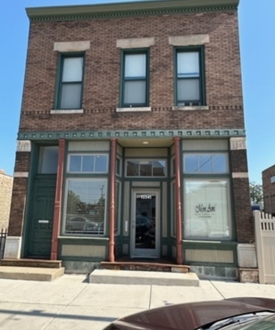 a view of a brick building with a door side of it